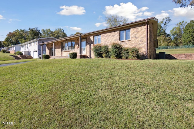 ranch-style house featuring central AC and a front lawn