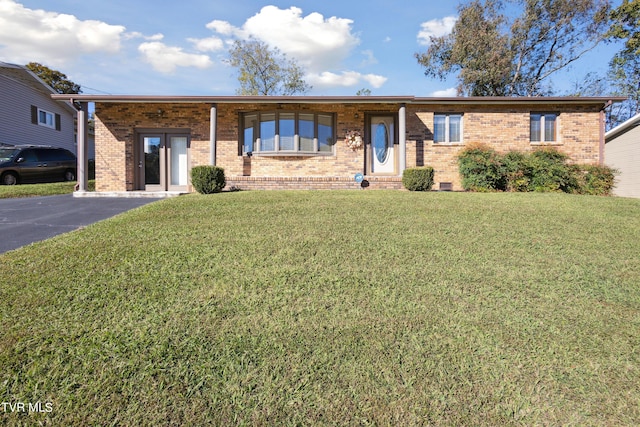 ranch-style home with brick siding and a front yard