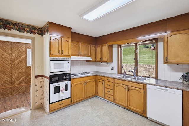 kitchen with sink, backsplash, and white appliances