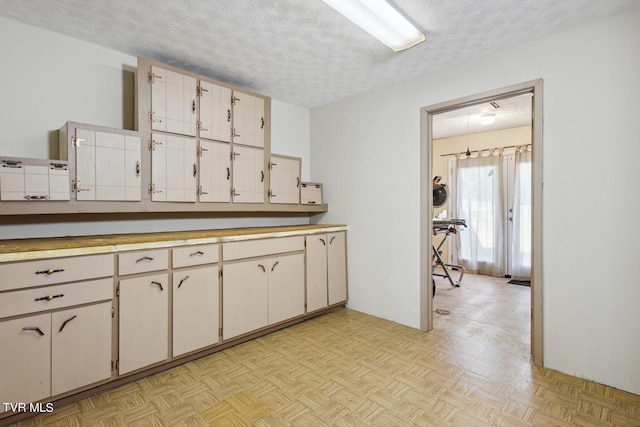 kitchen featuring a textured ceiling and light parquet flooring