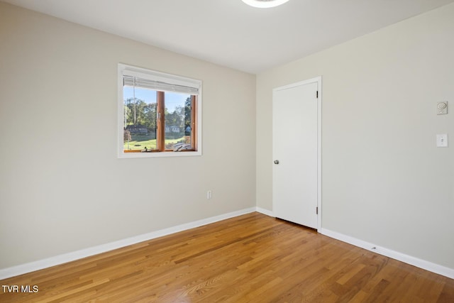 spare room with hardwood / wood-style flooring