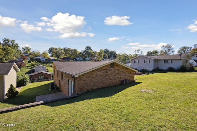 view of property exterior with cooling unit and a lawn