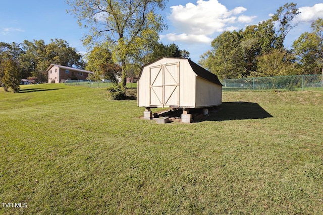 view of outbuilding with a yard