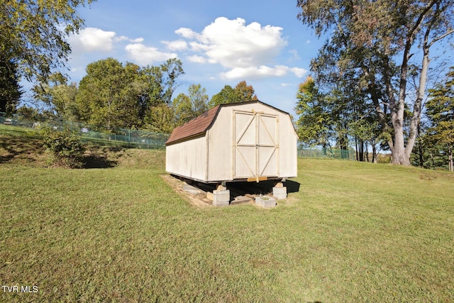 view of outdoor structure featuring a lawn