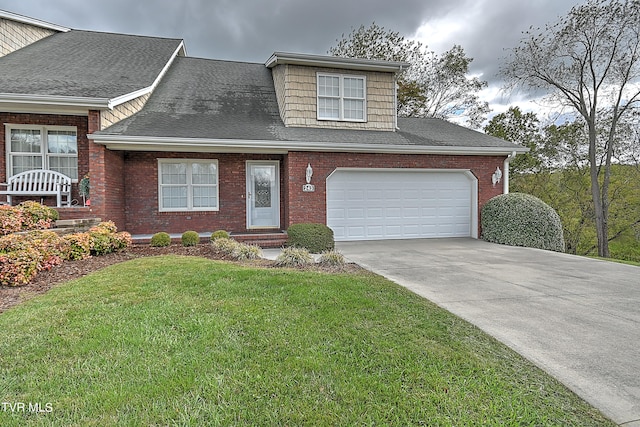 view of front of home with a front yard and a garage