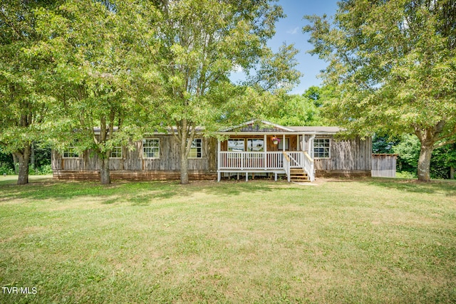 rear view of property featuring a yard