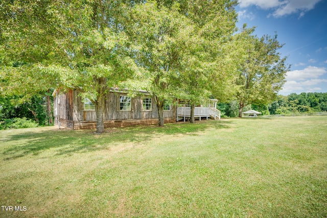 view of yard featuring a wooden deck