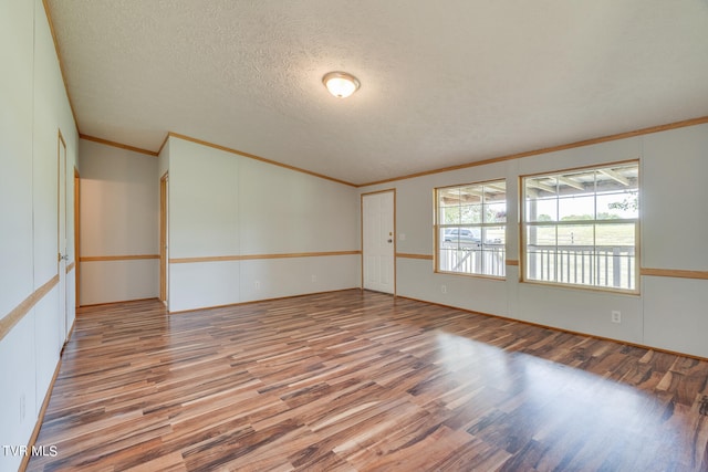 unfurnished room featuring ornamental molding, a textured ceiling, and hardwood / wood-style flooring