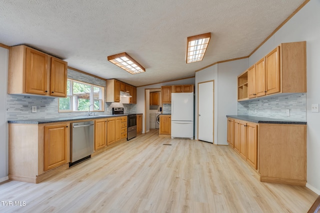 kitchen featuring crown molding, light hardwood / wood-style flooring, a textured ceiling, appliances with stainless steel finishes, and washer / clothes dryer