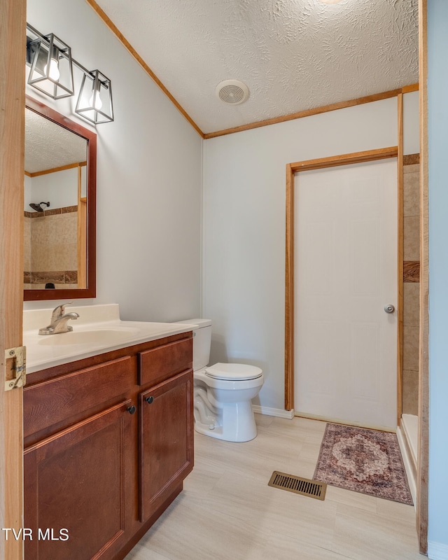 bathroom with vanity, hardwood / wood-style floors, a textured ceiling, and toilet