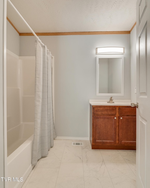 bathroom with shower / bath combo with shower curtain, vanity, a textured ceiling, and ornamental molding