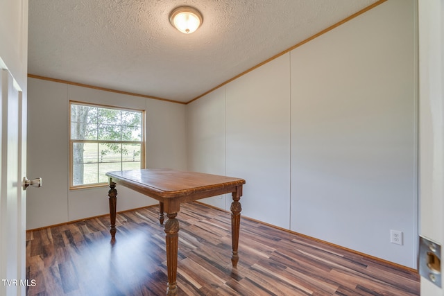 unfurnished office with dark hardwood / wood-style flooring, ornamental molding, and a textured ceiling