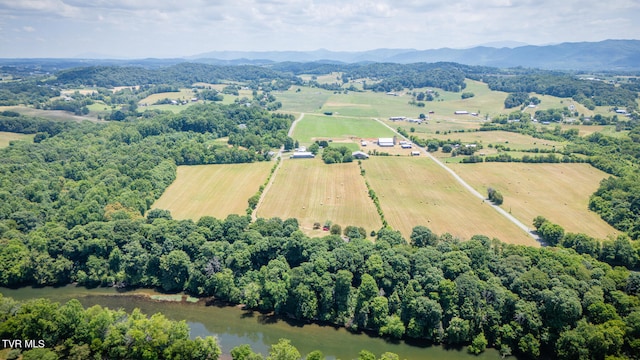 aerial view with a water and mountain view and a rural view