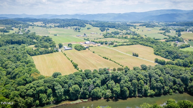 drone / aerial view featuring a rural view and a water and mountain view