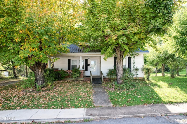 obstructed view of property featuring a porch and a front lawn