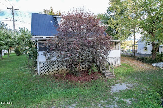 rear view of property with a yard