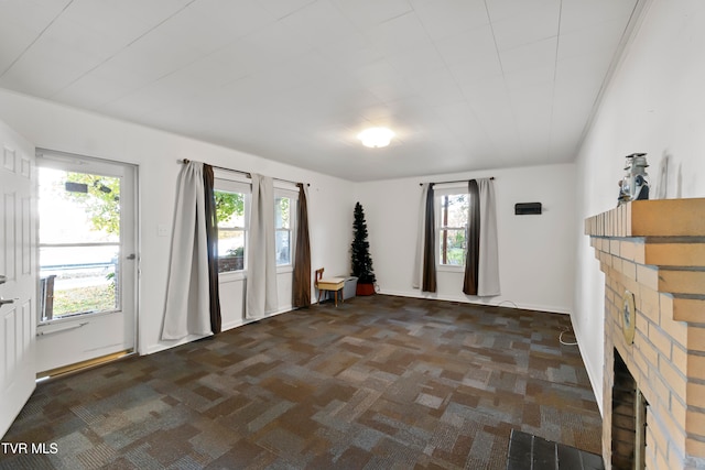 spare room with a brick fireplace