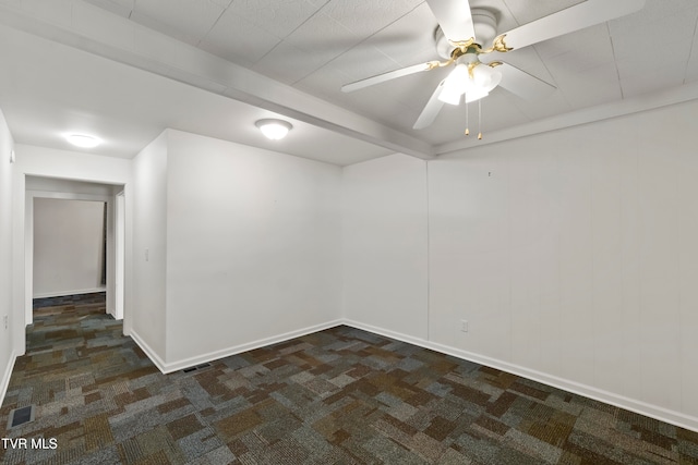 spare room with ceiling fan and dark carpet