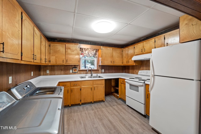 kitchen with white appliances, sink, separate washer and dryer, a paneled ceiling, and light hardwood / wood-style flooring