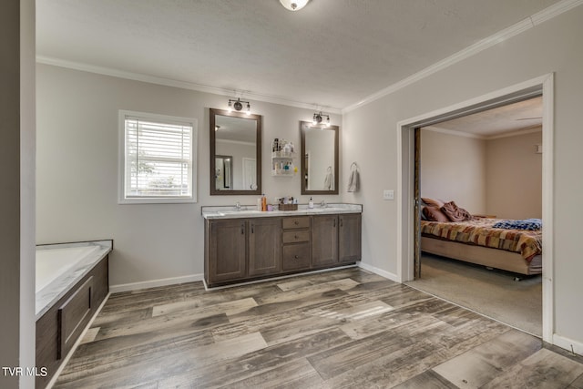 bathroom featuring vanity, hardwood / wood-style floors, a textured ceiling, and ornamental molding