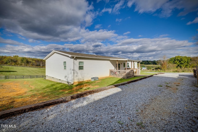 view of side of home with a lawn