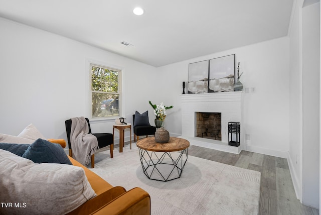 living room featuring light hardwood / wood-style flooring and a fireplace