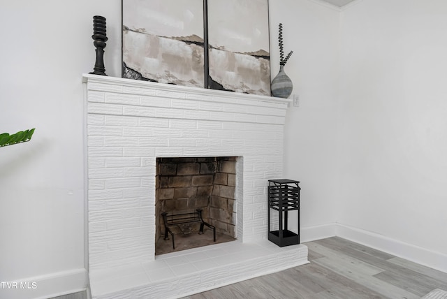 details featuring hardwood / wood-style flooring and a fireplace