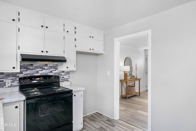 kitchen with black range with electric stovetop, light hardwood / wood-style flooring, white cabinets, and tasteful backsplash