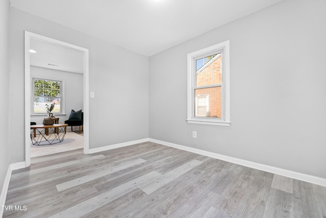 spare room featuring light hardwood / wood-style floors