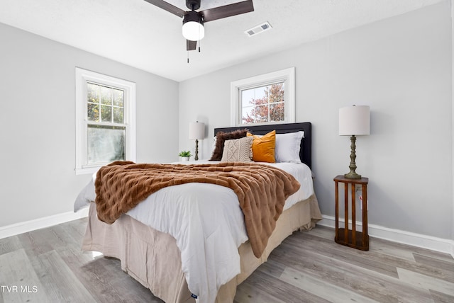 bedroom with light wood-type flooring and ceiling fan