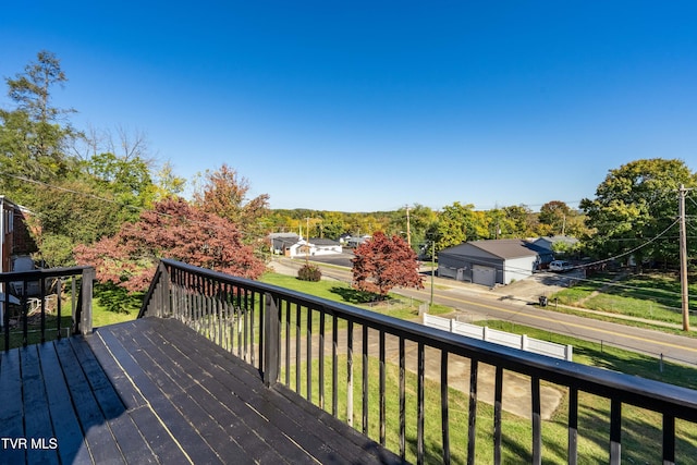 wooden deck with a lawn