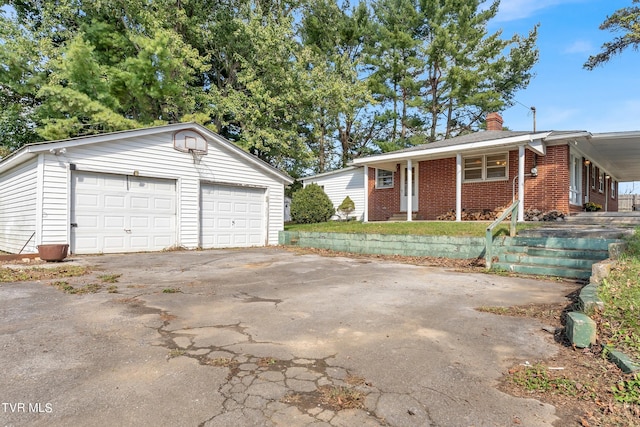 view of front of property featuring an outdoor structure and a garage