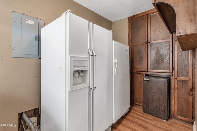 kitchen with white fridge with ice dispenser, electric panel, light hardwood / wood-style flooring, and white refrigerator