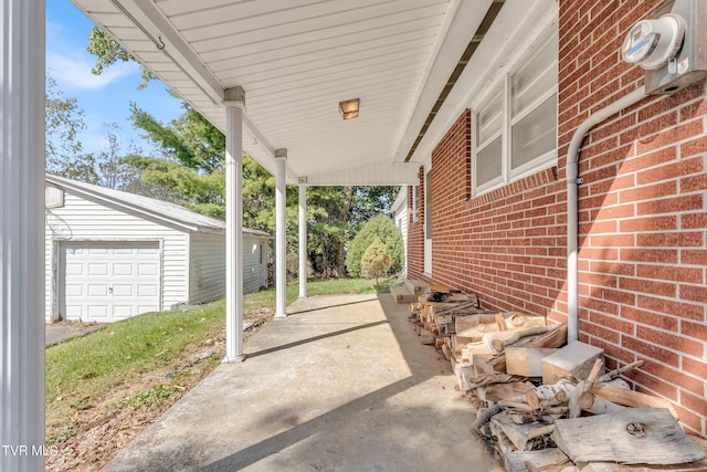 view of patio / terrace featuring an outbuilding and a garage