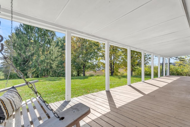 wooden deck featuring a yard