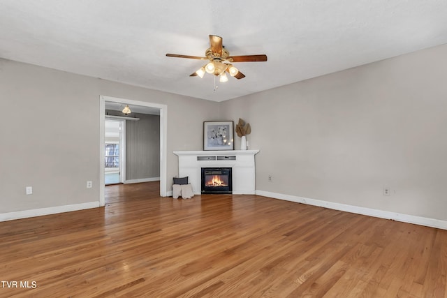 unfurnished living room with light hardwood / wood-style flooring and ceiling fan