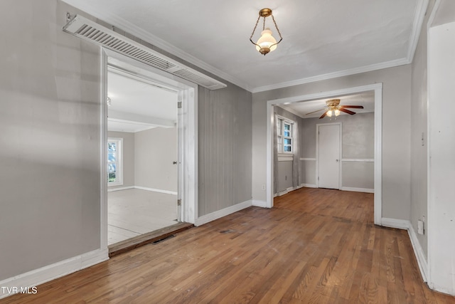 interior space with ornamental molding and hardwood / wood-style floors