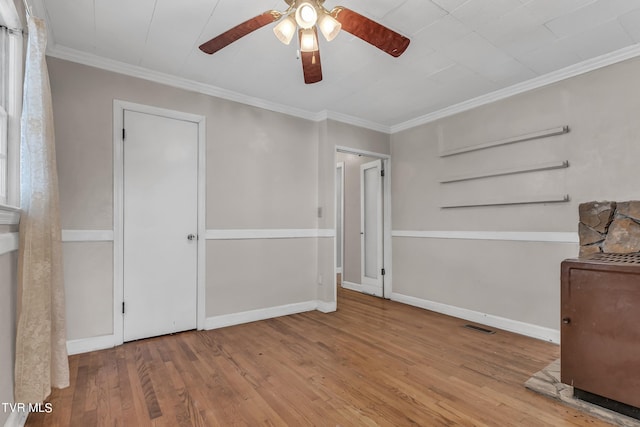 interior space featuring light hardwood / wood-style flooring, crown molding, and ceiling fan