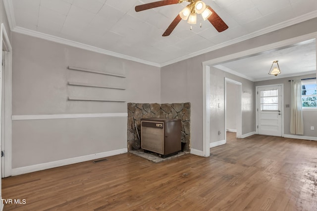 unfurnished living room with crown molding, hardwood / wood-style flooring, a fireplace, and ceiling fan