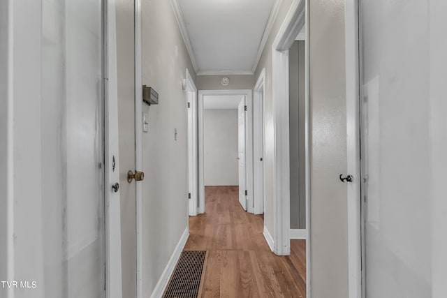 hall featuring ornamental molding and light wood-type flooring