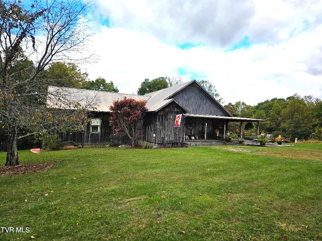 back of property featuring a yard