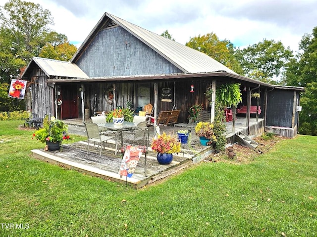 back of property featuring a yard