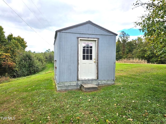 view of outbuilding featuring a yard