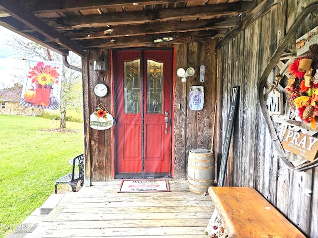 doorway to property featuring a lawn