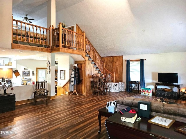 7503 Strawberry Mountain Rd, Wise, VA 24293 - living room featuring a ceiling fan, stairs, high vaulted ceiling, wooden walls, and wood finished floors