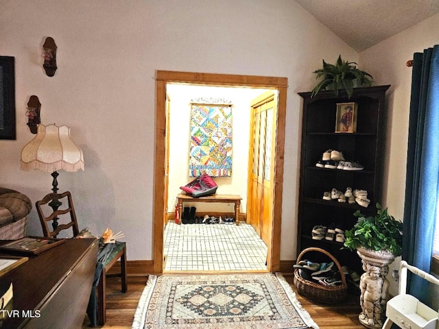 7503 Strawberry Mountain Rd, Wise, VA 24293 - hall with wood finished floors, vaulted ceiling, and baseboards