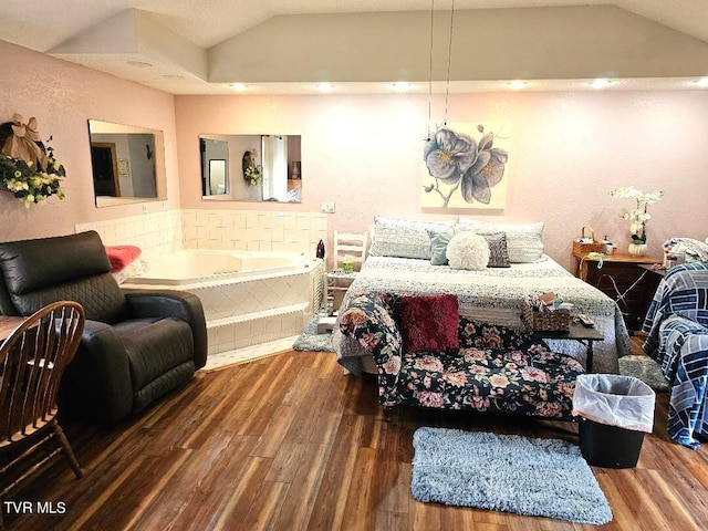 bedroom with lofted ceiling and hardwood / wood-style floors