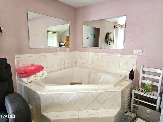 bathroom with a wealth of natural light and tiled bath