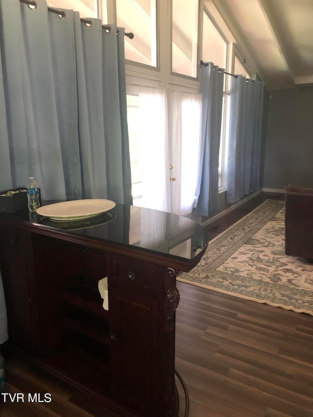 bathroom featuring vanity, vaulted ceiling, and wood-type flooring