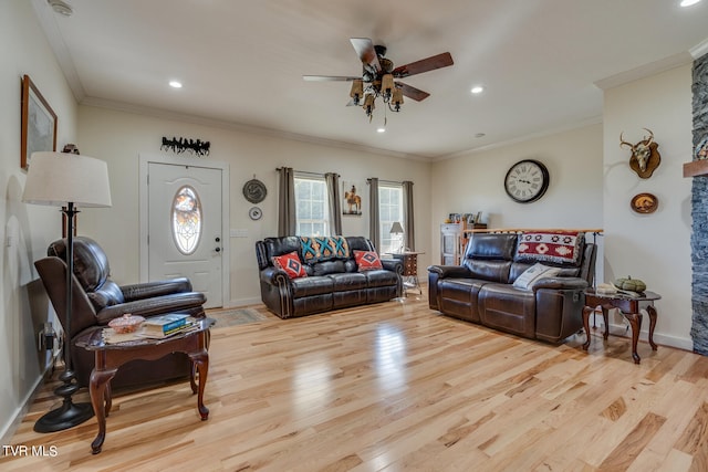 living room featuring crown molding, light hardwood / wood-style flooring, and ceiling fan